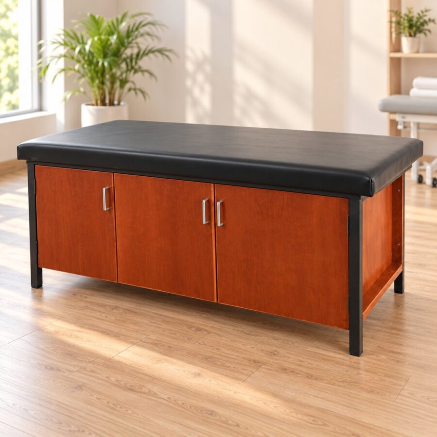 Treatment table with a black padded top and a wooden three door storage cabinet underneath